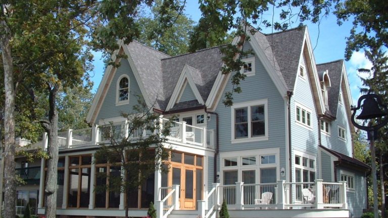 Devils Lake Gables, a lake house on Devils Lake, Michigan: the lakeside view with steep cross gables, a screened porch and a deck